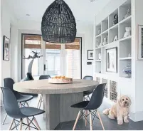  ?? JANE BEILES THE NEW YORK TIMES ?? Lower cabinets in a wall of shelves were refurbishe­d as custom dog kennels. Below, a pivoting wall in an apartment opens to create a bedroom with a Murphy bed and built-in shelves.