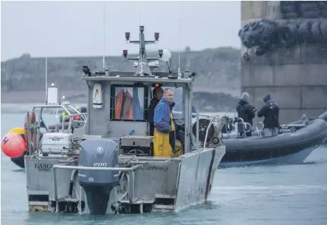  ??  ?? Dozens of French fishing boats arrive at the main port on the island of Jersey to form a protest flotilla AP