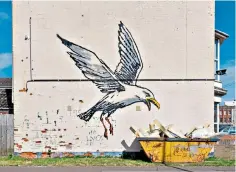  ?? ?? Smash and grab: a giant gull descending on a skip in Lowestoft, Suffolk, by Banksy