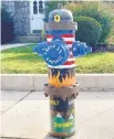  ??  ?? Christine Frobase painted this hydrant at North Third and North streets with a Scouting theme.