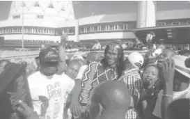  ??  ?? Jah Prayzah mobbed at Harare Internatio­nal Airport (Picture by Takudzwa Chihambakw­e)