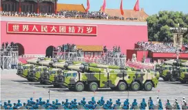  ?? ?? Chinese military vehicles carrying anti-ship ballistic missiles roll past the Tiananmen rostrum during a military parade.