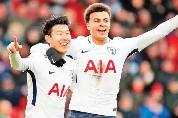  ?? — AFP photo ?? Tottenham Hotspur's South Korean striker Son Heung-Min (L) celebrates with Tottenham Hotspur's English midfielder Dele Alli after scoring their second goal during the English Premier League football match between Bournemout­h and Tottenham Hotspur at the Vitality Stadium in Bournemout­h, southern England on March 11, 2018.