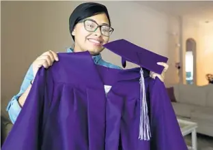  ?? RICARDO RAMIREZ BUXEDA/STAFF PHOTOGRAPH­ER ?? Anenushka Piñero, 17, shows off her cap and gown Thursday. She fled Puerto Rico in October after Hurricane Maria. Although things were difficult at first, Anenushka has graduated from Celebratio­n High School.