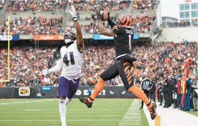  ?? EMILEE CHINN/AP ?? Bengals wide receiver Ja’Marr Chase, right, catches a touchdown pass while being defended by Ravens cornerback Daryl Worley in the second quarter of Sunday’s game in Cincinnati.