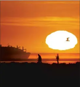  ?? Luis Sinco Los Angeles Times ?? ANGLERS set up at the San Gabriel River jetty Thursday in Long Beach. The Weather Service is advising people to be careful with potential ignition sources.