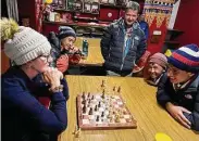  ?? ?? Marga Kellogg Cooley plays a game of chess with one of the porters. She lost.