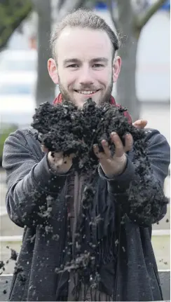  ?? PHOTO: GERARD O’BRIEN ?? Rich compost . . . Student Finn Boyle runs his hands through some soil at the Otago Polytechni­c yesterday.