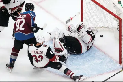  ?? The Canadian Press ?? Colorado Avalanche forward Gabriel Landeskog and Arizona Coyotes’ Alex Goligoski battle as the Avs score on Darcy Kuemper during the third period of their Stanley Cup playoff game in Edmonton on Wednesday. Colorado won 3-0. More scores on page B2.