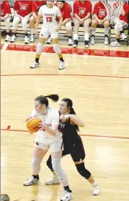  ?? MARK HUMPHREY/ ENTERPRISE-LEADER ?? Farmington sophomore Zoey Bershers posts up against a shorter Gentry defender. The 6-feet-3 center scored a team-high 16 points to lead Farmington to a 56-37 win over the Lady Pioneers on Friday as the Lady Cardinals celebrated Colors Day.