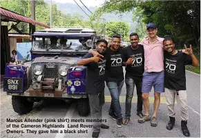  ??  ?? Marcus Allender (pink shirt) meets members of the Cameron Highlands Land Rover Owners. They gave him a black shirt