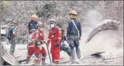  ?? REUTERS ?? Rescue workers remove ash at an area hit by the volcano.