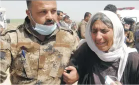  ?? THE
ASSOCIATED
PRESS ?? An Iraqi Yazidi woman, right, released by ISIL militants is helped as she arrives in Kirkuk, 290 kilometres north of Baghdad, on Wednesday.