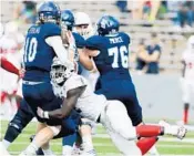  ?? GETTY IMAGES FILE ?? FAU’s defense will be challenged by a Wisconsin offense gained 234 rushing yards on 45 carries last week.