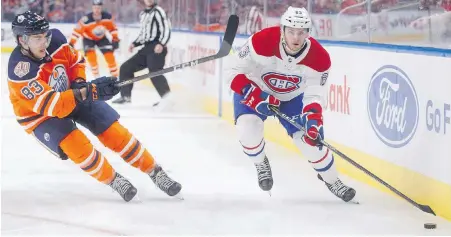  ?? JASON FRANSON, THE CANADIAN PRESS ?? The Oilers’ Matthew Benning, left, chases Montreal’s Matthew Peca Tuesday night in Edmonton.