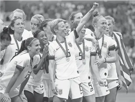  ?? MICHAEL CHOW/ USA TODAY SPORTS ?? U. S. forward Megan Rapinoe ( 15) and teammates celebrate after beating the Netherland­s to win the FIFA Women’s World Cup in 2019.