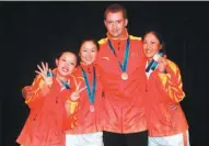  ?? PROVIDED TO CHINA DAILY ?? From left: Li Jiayun, Yan Jing, Gareth Winslow and Lin Xiyu pose with medals after China finished second in the team competitio­n at the 2010 Guangzhou Asian Games.