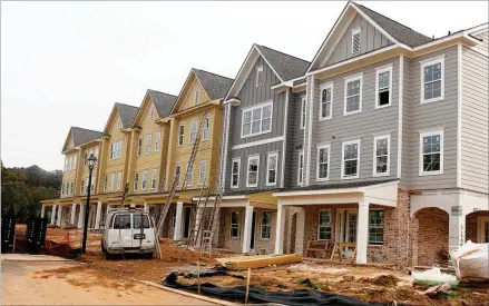  ?? TYLER WILKINS/TYLER.WILKINS@AJC.COM ?? Parkland Communitie­s is finishing up two of four townhome sections within its Sweetwater Springs build-to-rent community off Duluth Highway. More than 200 people are on a waiting list for one of the units.