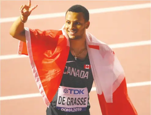  ?? Ahmed Jadallah
/ Reuters files ?? Canada’s Andre De Grasse celebrates winning silver in the men’s 200 metres at the 2019 World Athletics Championsh­ip in Doha, Qatar. The sprinter is looking forward to competing in the postponed Tokyo 2020 Olympics.