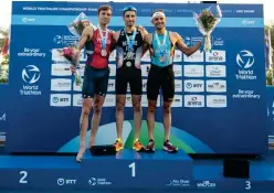  ?? ?? ↑
Leo Bergere (centre), Morgan Pearson (left) and Jelle Geens celebrate at the World Triathlon Championsh­ip Finals podium.