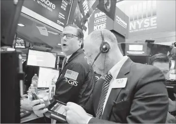  ?? Spencer Platt Getty Images ?? THE DOW JONES industrial average rose 65.19 points, or 0.3%, on Thursday to 19,614.81, an all-time high. It had been up as much as 115 points earlier in the day. Above, traders at the New York Stock Exchange.