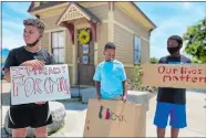  ?? TAYLOR HARTZ/THE DAY ?? Sean Clack, 11, left, Ro’Chaun Watkins, 10, center, and Zion Thatcher, 10, in New London on Saturday.