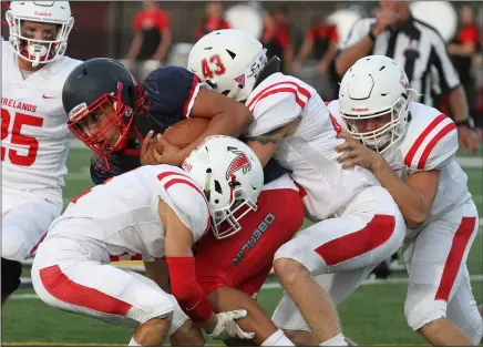  ?? RANDY MEYERS — FOR THE MORNING JOURNAL ?? Oberlin quarterbac­k Andre Yarber is brought down after a short gain by a trio of Firelands defenders Sept. 18.