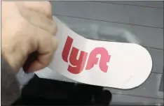  ?? GENE J PUSKAR AP ?? A LYFT logo is installed on a Lyft driver’s car in Pittsburgh.