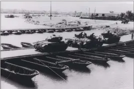  ?? LOANED PHOTO ?? M4 SHERMAN TANKS, THE MOST common American tank of World War II, cross the Colorado River on a temporary pontoon bridge. Many bridge designs were tested at the Yuma Test Station during the war years to take the place of concrete and steel bridges...