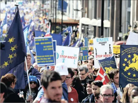  ?? PHOTO: BLOOMBERG ?? Anti Brexit campaigner­s carry flags and banners as they march towards Britain’s parliament in London on Saturday. Britain’s Prime Minister Theresa May is expected to start the process of leaving the EU tomorrow.