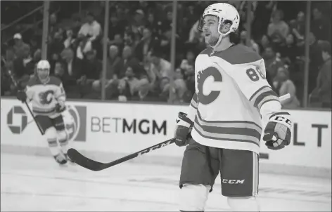  ?? JOHN MINCHILLO/AP ?? CALGARY FLAMES LEFT WING ANDREW MANGIAPANE reacts after scoring on New York Rangers goaltender Igor Shesterkin during the second period of a game on Oct. 25, 2021, in New York.