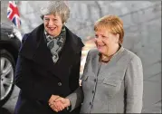  ?? KRISZTIAN BOCSI / BLOOMBERG ?? British Prime Minister Theresa May (left) shakes hands with German Chancellor Angela Merkel before talks in Berlin on Tuesday.