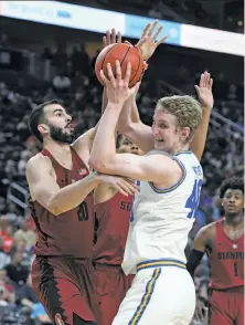  ?? Ethan Miller / Getty Images ?? Stanford’s Josh Sharma (left) and UCLA’s Thomas Welsh fight for a rebound during a Pac-12 quarterfin­al in Las Vegas.