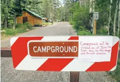  ??  ?? A handwritte­n sign at the Black Canyon Campground in the Santa Fe National Forest warns visitors Wednesday afternoon of the impending forest closure. The Santa Fe National Forest will be closed due to fire restrictio­ns beginning Friday.