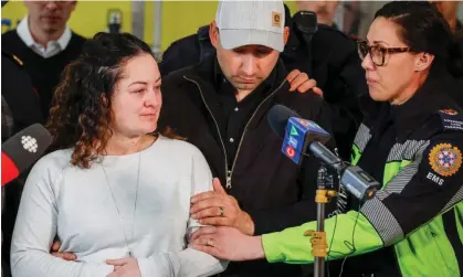  ?? Photograph: Canadian Press/Rex/Shuttersto­ck ?? Jayme Erickson, left, is comforted by her husband, Sean Erickson, centre, and friends as she speaks to the media in Airdrie, Alberta.