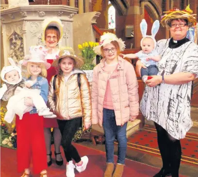  ??  ?? ●●Taking part in the Easter Bonnet Parade at St Andrew’s, Dearnley, are these youngsters with the vicar, the Rev Rachel Battershel­l and the church’s child protection officer Sheila Moore