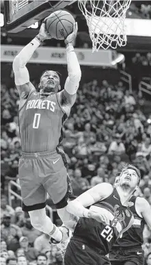  ?? Melissa Phillip / Staff photograph­er ?? Rockets guard Russell Westbrook goes to the basket and draws a foul against the Bucks’ Kyle Korver. Westbrook finished with 24 points, 16 rebounds and seven assists.