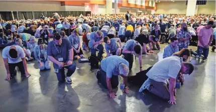  ?? Nashville, Tenn. ANDREW NELLES/THE TENNESSEAN VIA USA TODAY NETWORK ?? Southern Baptists gather in prayer June 15 during the annual Southern Baptist Convention meeting at Music City Center in