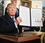  ?? CHIP SOMODEVILL­A / GETTY IMAGES ?? President Donald Trump holds a proclamati­on declaring that the U.S. will recognize Jerusalem as the capital of Israel in December 2017.