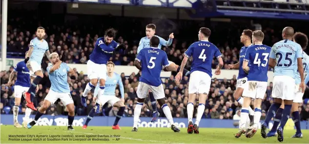  ?? — AP ?? Manchester City’s Aymeric Laporte ( centre), scores against Everton in their Premier League match at Goodison Park in Liverpool on Wednesday.