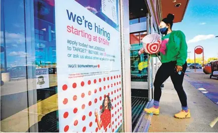  ?? STEVEN SENNE AP ?? A hiring sign at a Target store in Westwood, Mass., belies an overall drop in ser vice-sector jobs in the U.S. during this recession.