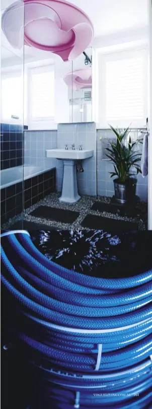  ??  ?? this page: bathroom laid with blue-stone pavers and granite aggregate from Bunnings; custom pink light fitting fashioned from a deconstruc­ted fibreglass coffee table. A chimney cleaner inserted into a stack of coiled blue garden hose elevates the...