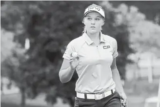  ?? KATIE RAUSCH THE BLADE VIA THE ASSOCIATED PRESS ?? Brooke Henderson reacts after sinking her putt on the ninth green during the third round of the LPGA Marathon Classic golf tourney at Highland Meadows Golf Club in Sylvania, Ohio, on Saturday.