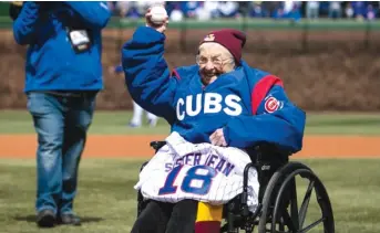  ?? ASHLEE REZIN/ SUN- TIMES ?? Sister Jean Dolores- Schmidt, the 98- year- old chaplain of the Loyola men’s basketball team, throws a ceremonial first pitch before the Cubs’ home opener Tuesday against the Pirates.