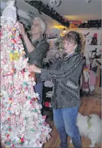  ?? SUBMITTED PHOTOS ?? Hal Higgins and wife Wilma Menzies are putting the finishing touches on the “Candy Tree” which is featured with many other beautiful Christmas decoration­s and decor at the newly opened Victorian Christmas Gift Shoppe in Marion Bridge, 2719 Grand Mira North Road.
