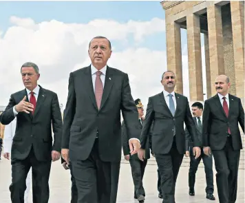  ??  ?? President Erdogan (front) and members of his Supreme Military Council yesterday: Turkey has vowed to retaliate against Washington’s sanctions ‘without delay’