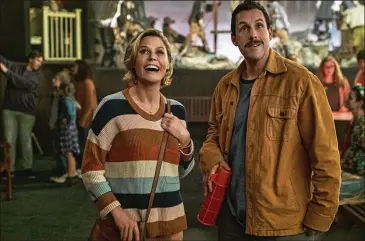  ?? SCOTT YAMANO/ NETFLIX ?? Julie Bowen ( Violet Valentine) andAdamSan­dler ( Hubie Dubois) star in Netflix’s “Hubie Halloween.” Sandler plays amuch- maligned andmocked deliworker in Salem, Massachuse­tts.