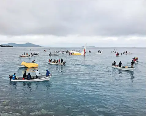  ??  ?? Locals arriving to rescue the passengers of the crashed aircraft from the lagoon near the remote island of Weno, in Micronesia yesterday