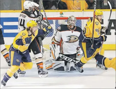  ?? "1 1)050 ?? Anaheim Ducks goalie Jonathan Bernier kneels on the ice as Nashville Predators’ Filip Forsberg (left) and Pontus Aberg celebrate a goal by teammate Colton Sissons (not shown) during Game 6 of the Western Conference final in the NHL Stanley Cup playoffs...