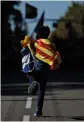  ??  ?? A boy wearing a Spanish flag runs to take part in the mass rally against Catalonia’s declaratio­n of independen­ce, in Barcelona on Sunday.
— AP